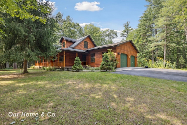 log home with covered porch, a garage, and a front lawn