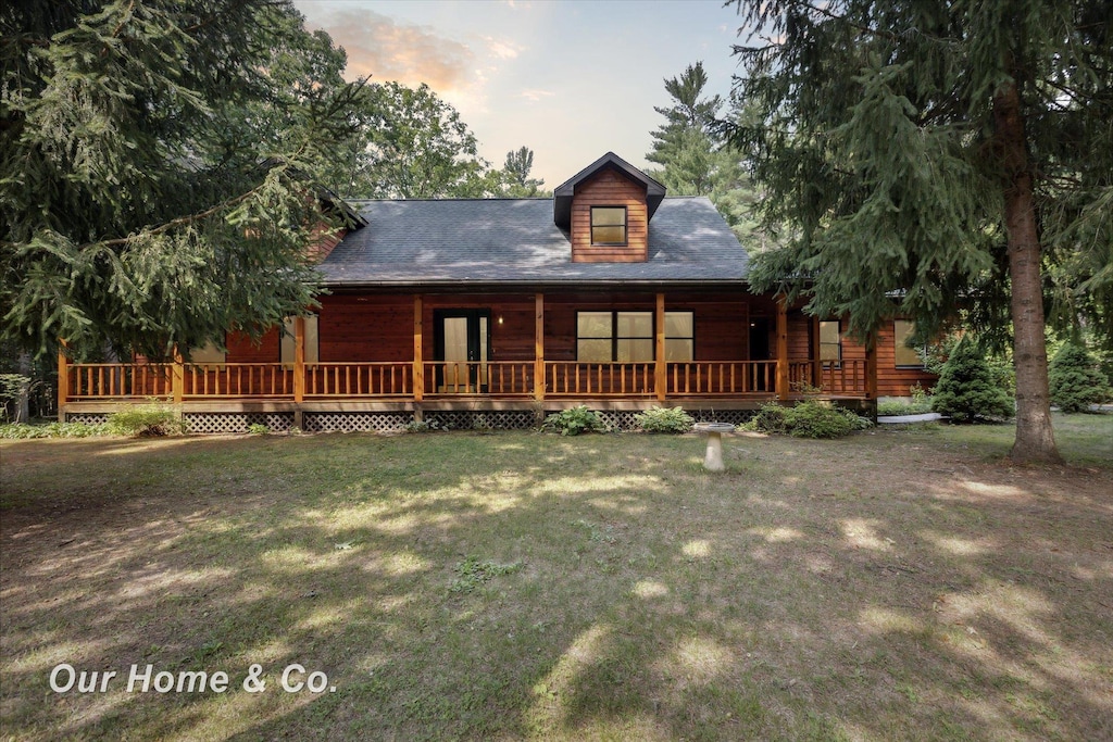 log-style house featuring a yard