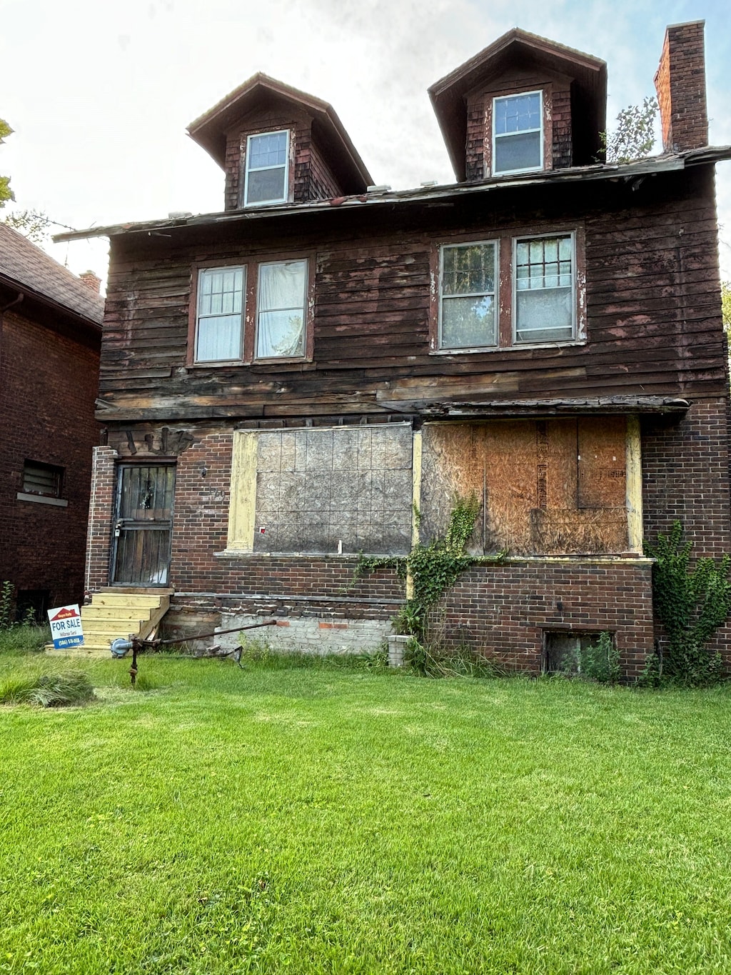 back of house with a lawn