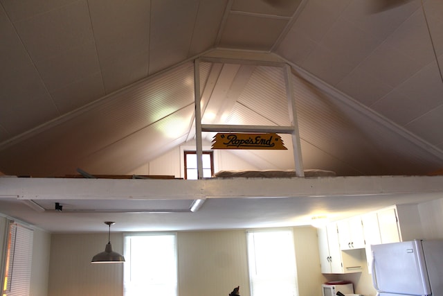 interior details featuring white fridge and pendant lighting