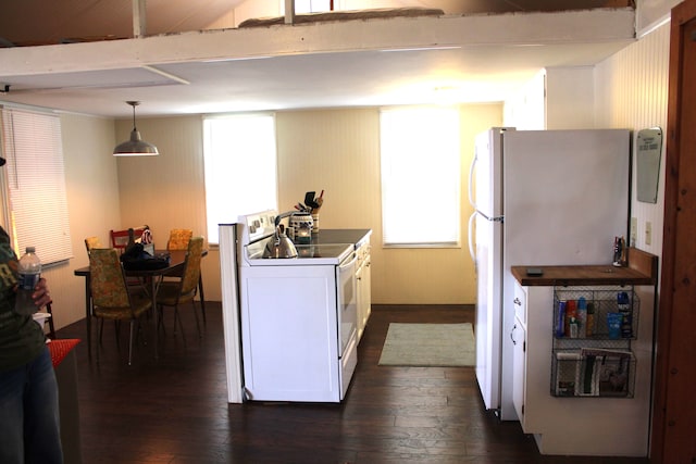 kitchen with white cabinetry, decorative light fixtures, dark wood-type flooring, and white appliances