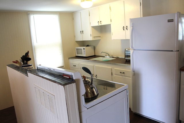 kitchen with white cabinets, white appliances, and sink