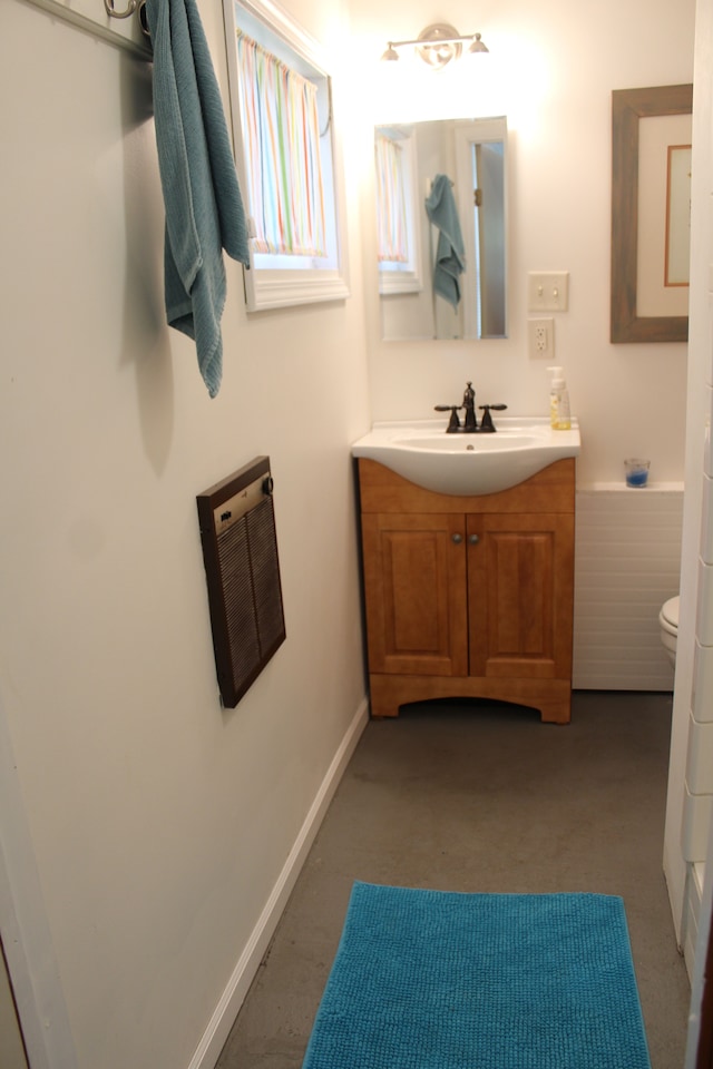 bathroom featuring vanity, toilet, and concrete floors