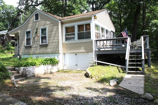 exterior space with a wooden deck and a sunroom