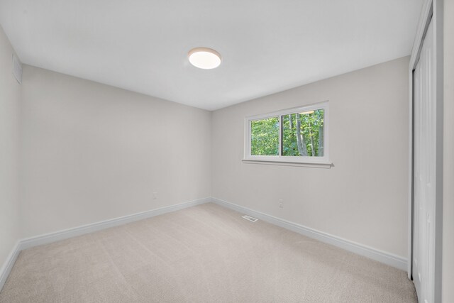 unfurnished room with light carpet