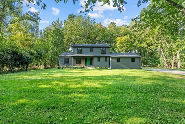 rear view of property featuring a yard