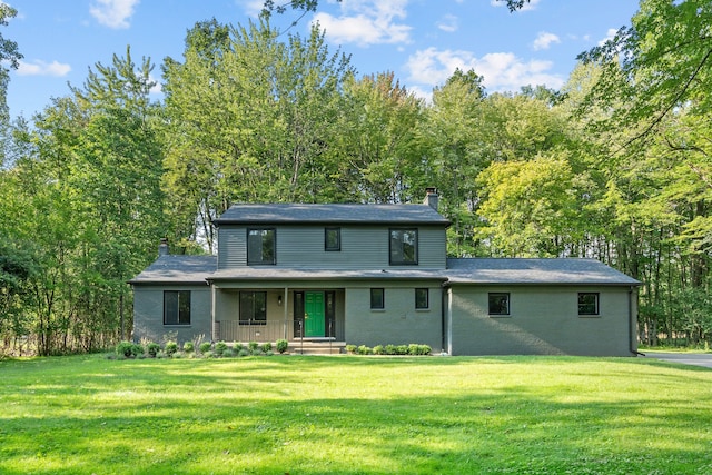 view of front of house featuring a front yard and covered porch