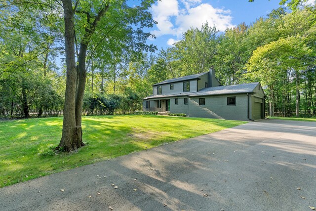 view of front of home featuring a garage and a front lawn