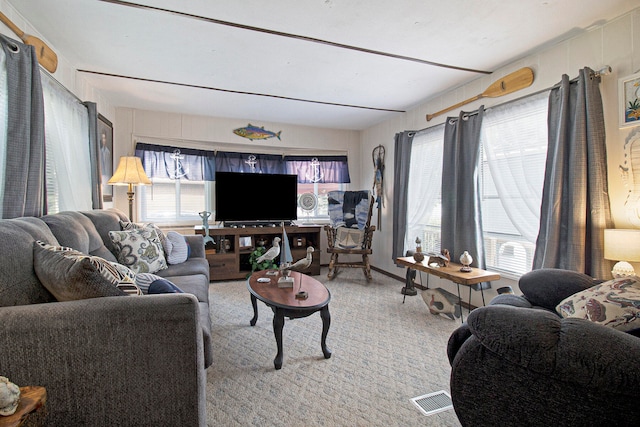 living room featuring a healthy amount of sunlight and light carpet