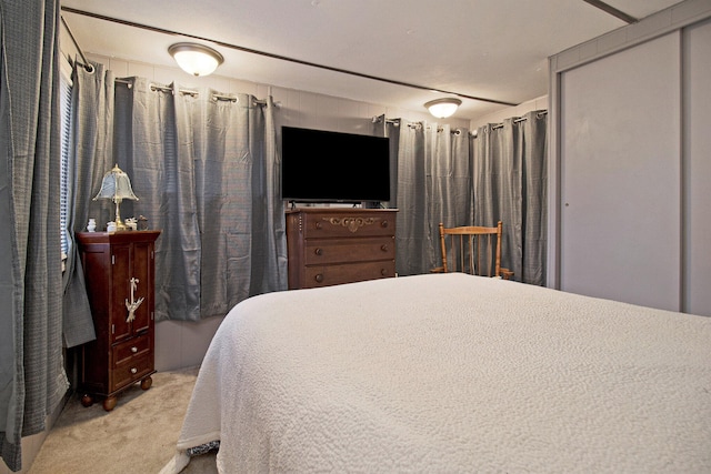 bedroom featuring light colored carpet