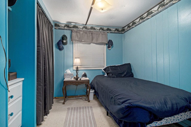 carpeted bedroom with wood walls