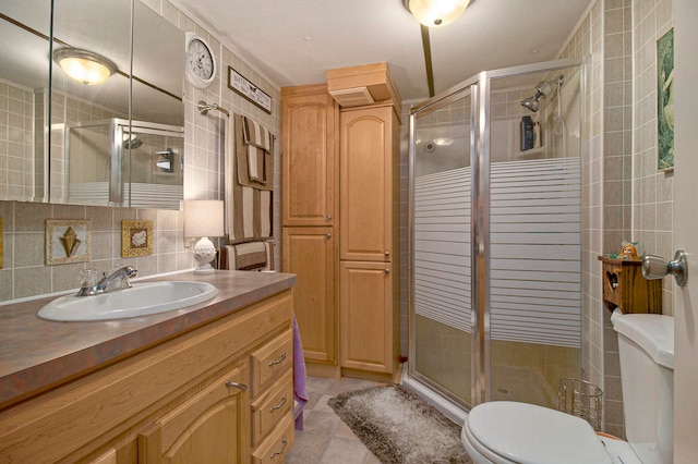 bathroom featuring backsplash, a shower with door, and tile walls