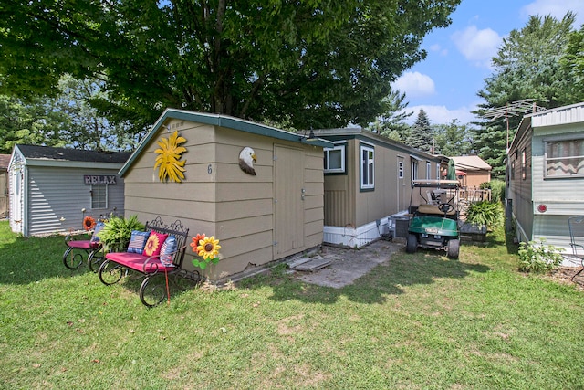 view of outbuilding featuring a yard