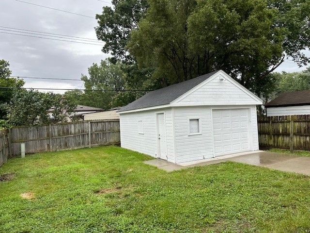 garage featuring a lawn