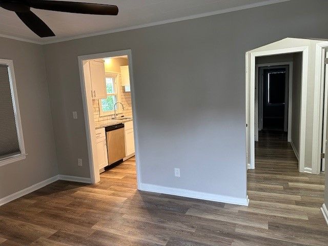 unfurnished room with crown molding, ceiling fan, and hardwood / wood-style flooring