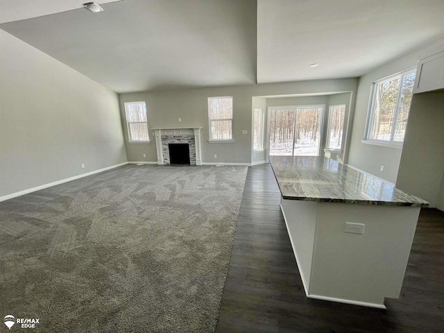 unfurnished living room featuring dark hardwood / wood-style floors and a fireplace