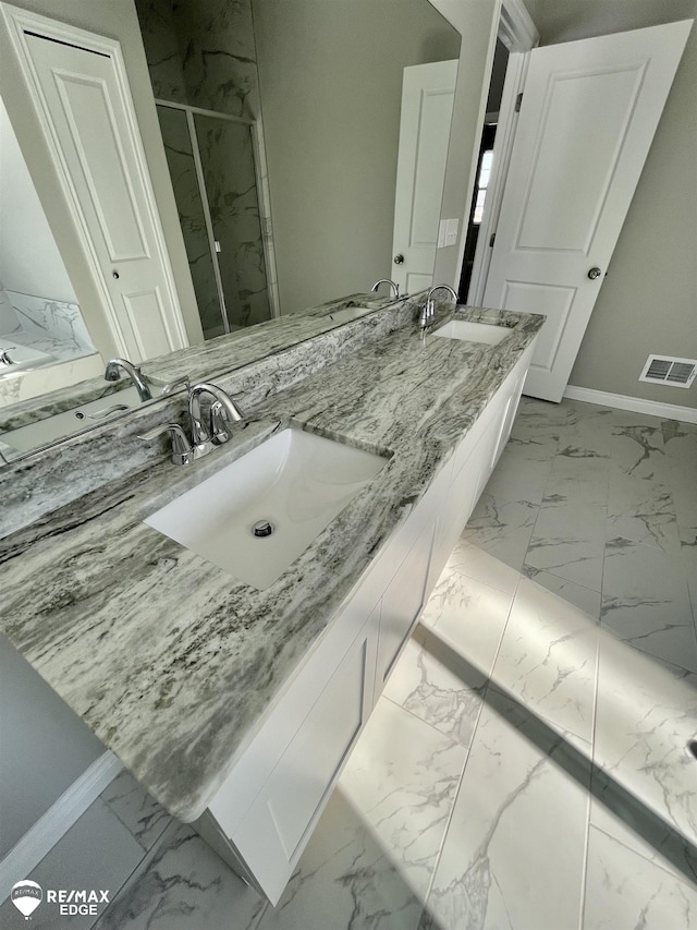 bathroom featuring vanity and a shower with door