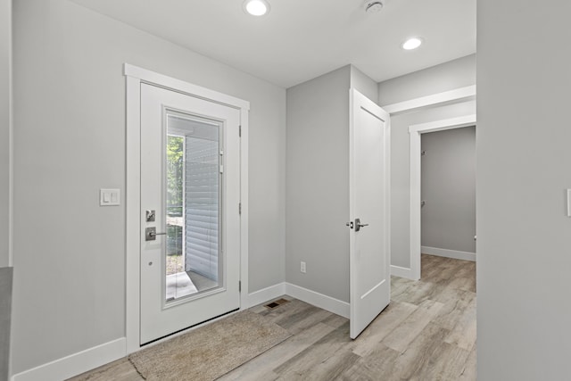 foyer entrance featuring plenty of natural light and light wood-type flooring