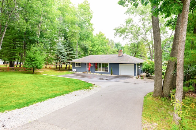 ranch-style home featuring a front lawn and a garage