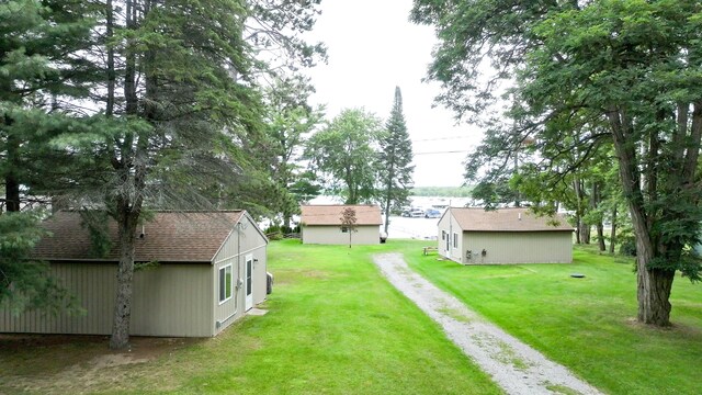1130 W Higgins Lake Dr, Roscommon, MI 48653 - view of green lawn featuring driveway