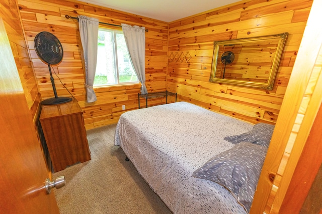 bedroom featuring wooden walls and carpet floors