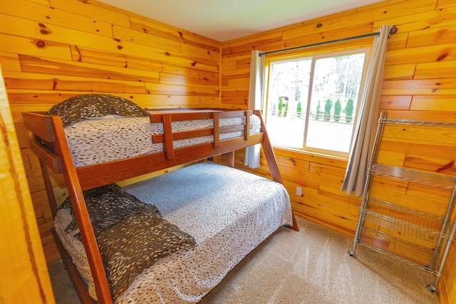 bedroom featuring carpet flooring and wood walls