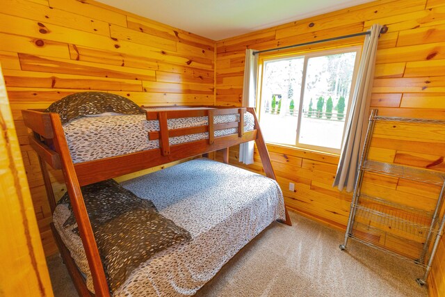 1130 W Higgins Lake Dr, Roscommon, MI 48653 - carpeted bedroom featuring wood walls