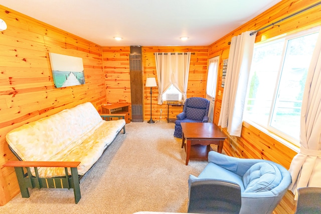 living room featuring carpet flooring and wooden walls