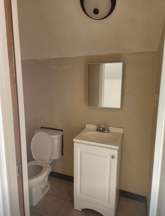 bathroom featuring tile patterned floors, vanity, and toilet