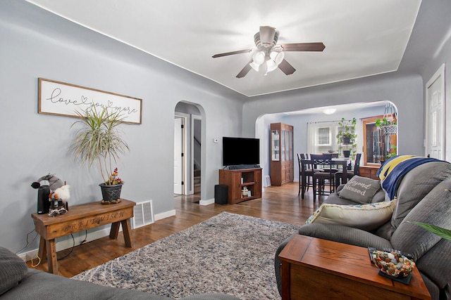 living room featuring wood-type flooring and ceiling fan