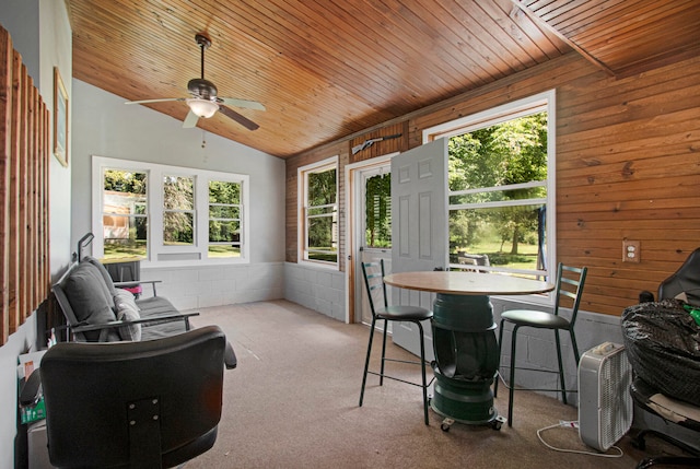 sunroom / solarium featuring ceiling fan, lofted ceiling, and wooden ceiling