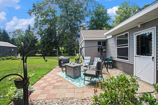 view of patio / terrace featuring an outdoor living space with a fire pit