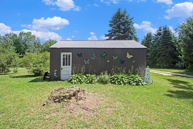 view of outdoor structure featuring a lawn