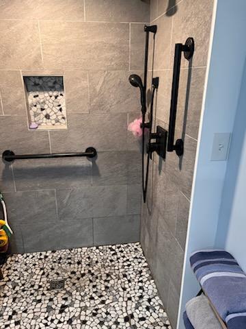 bathroom with tiled shower