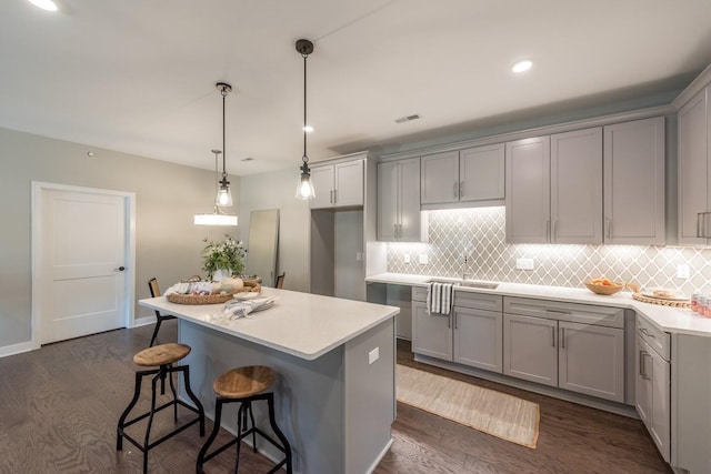 637 Woodland Dr, Dexter, MI 48130 - kitchen featuring gray cabinetry, tasteful backsplash, a sink, and recessed lighting