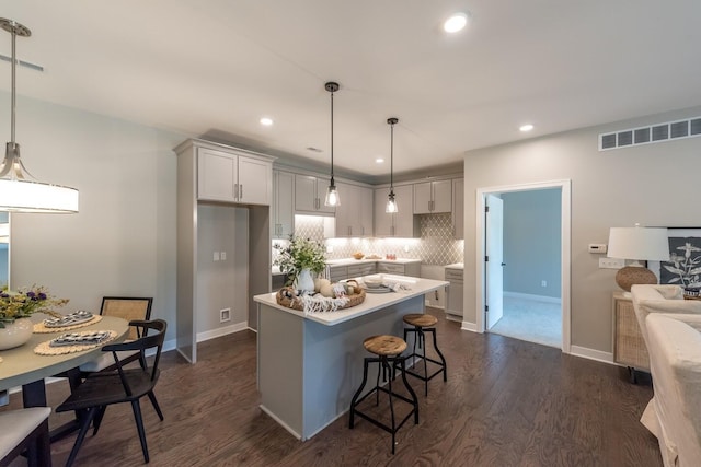 637 Woodland Dr, Dexter, MI 48130 - kitchen featuring backsplash, dark wood-type flooring, a center island, decorative light fixtures, and recessed lighting