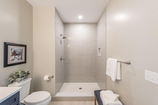 637 Woodland Dr, Dexter, MI 48130 - bathroom with toilet, a tile shower, and vanity
