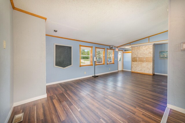 9284 M-35, Gladstone, MI 49837 - spare room featuring crown molding, dark wood-type flooring, baseboards, lofted ceiling, and a textured ceiling