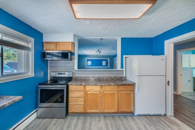 9284 M-35, Gladstone, MI 49837 - kitchen with appliances with stainless steel finishes, baseboard heating, light wood-style floors, dark countertops, and brown cabinetry