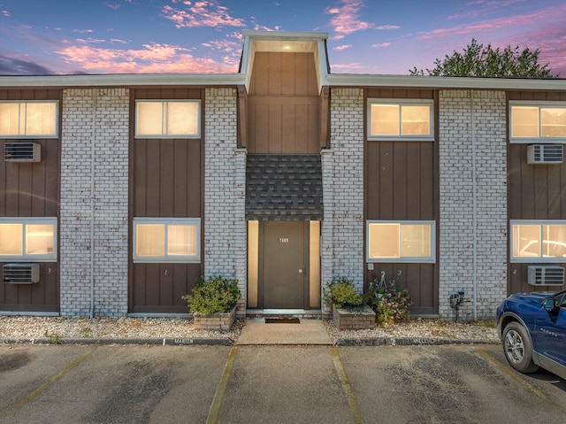 outdoor building at dusk with a wall unit AC