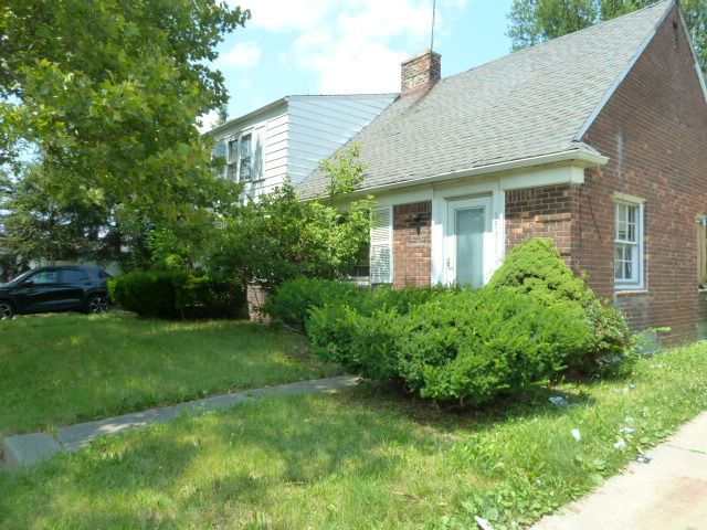 view of side of home featuring a yard