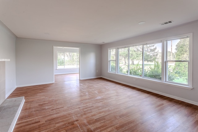 unfurnished room with light hardwood / wood-style flooring and plenty of natural light