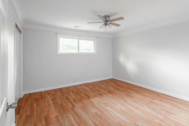 empty room with ceiling fan and light hardwood / wood-style floors