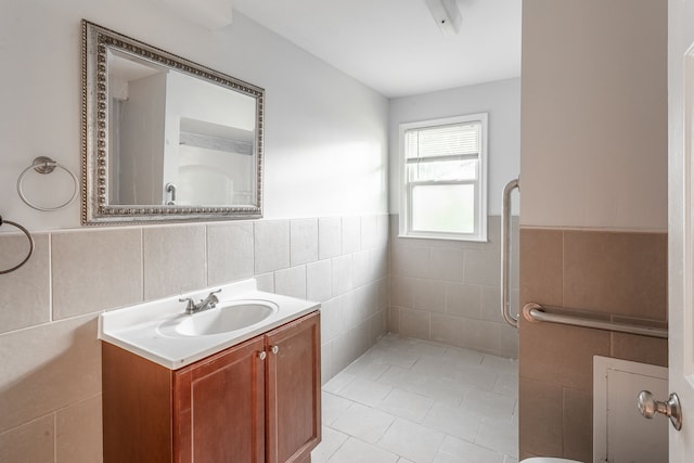 bathroom with tile patterned floors, vanity, and tile walls