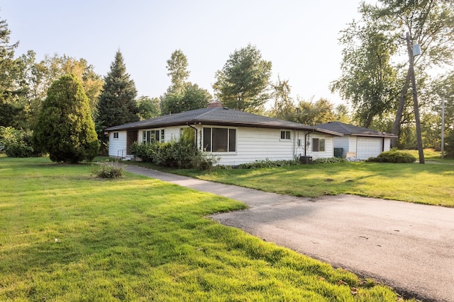 single story home with a front lawn and a garage