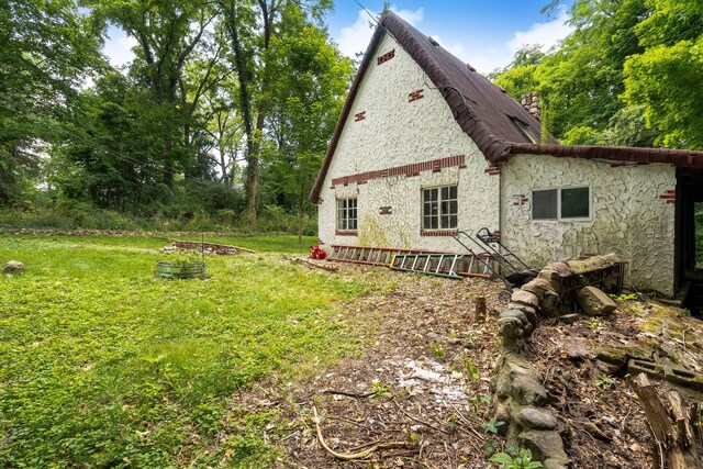 43550 Reservoir St, Plymouth, MI 48170 - rear view of house with a chimney and a yard