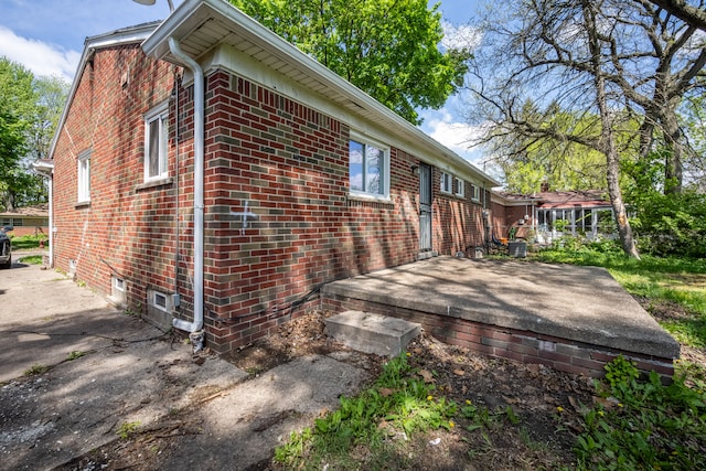 view of side of property featuring brick siding