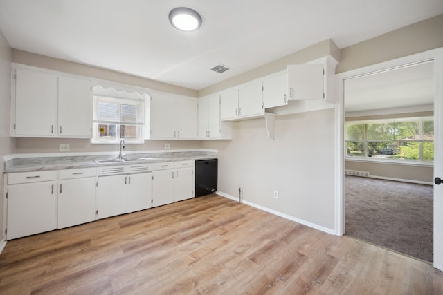 kitchen featuring a sink, black dishwasher, white cabinets, and baseboards