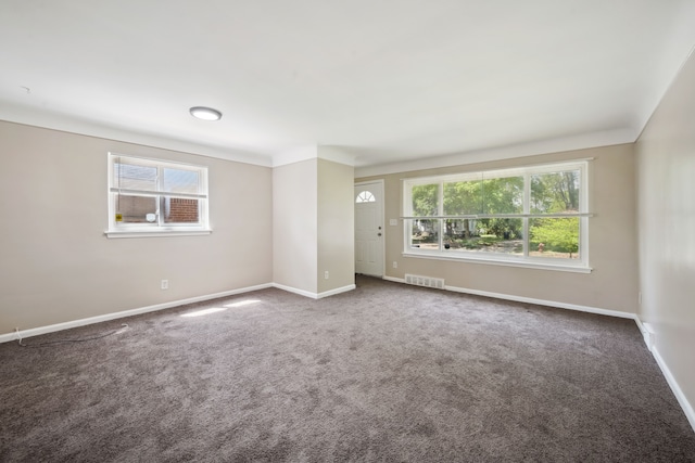 carpeted empty room with baseboards