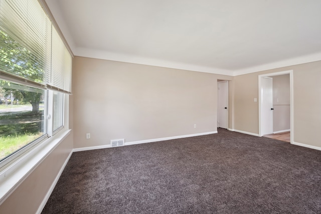 carpeted spare room with baseboards